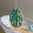 Load image into Gallery viewer, Decorative Easter egg with floral patterns on a white basket with straw and a small blue bunny. (Green)
