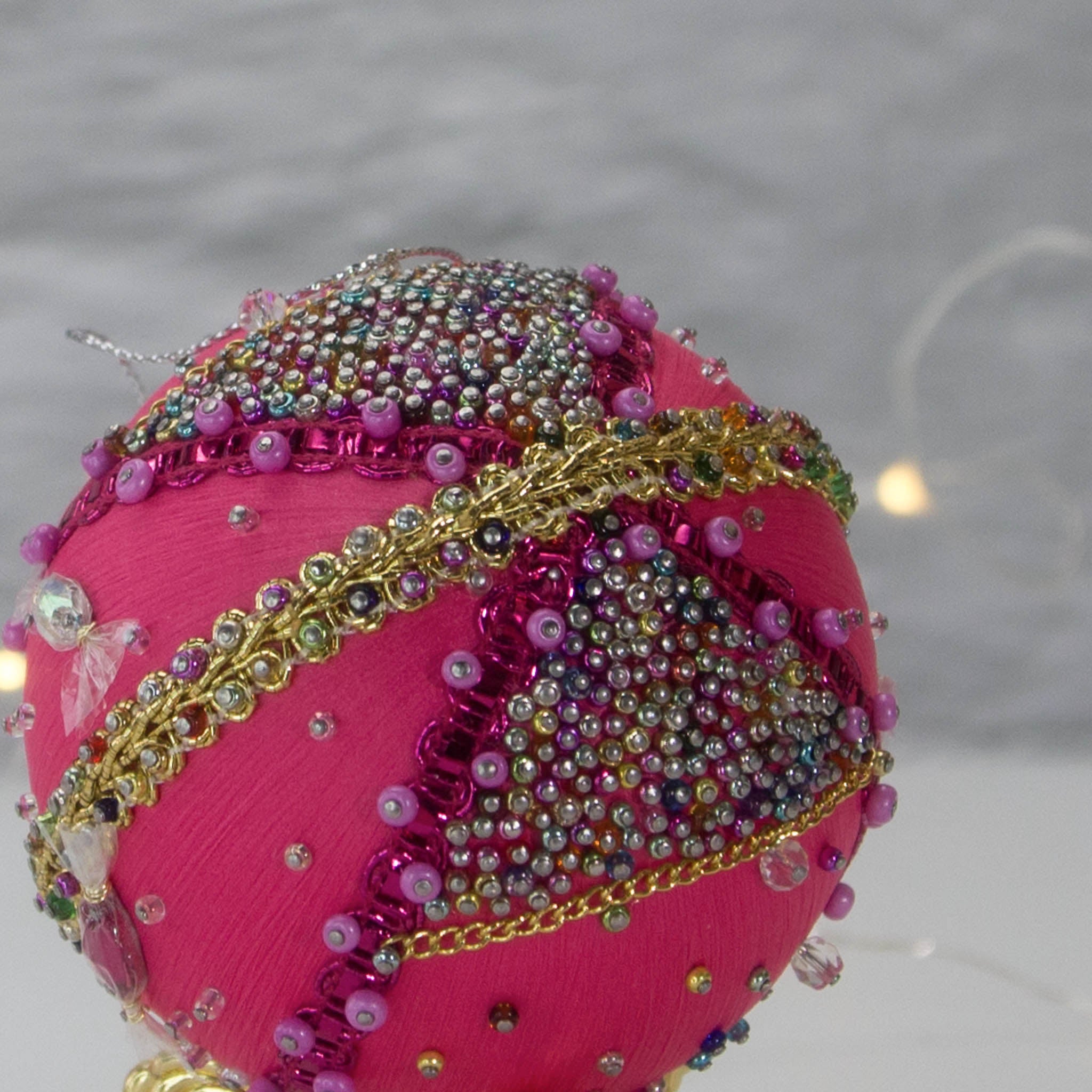 A close-up of Handmade Christmas Ornament Candy by Whim5seasons - thousand of Miyuki seed beads, meticulously applied one by one by hand. (Deep Pink) 