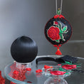 Load image into Gallery viewer, Finished ornament and a white satin ball with decorative items, embroide3red red roses patches on a dark background. (Black)
