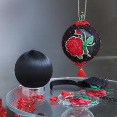 Finished ornament and a white satin ball with decorative items, embroide3red red roses patches on a dark background. (Black)