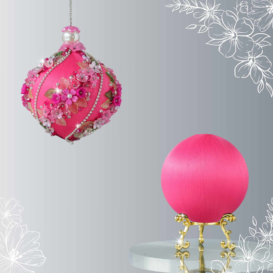 Decorative pink ornament with floral details on a gray background