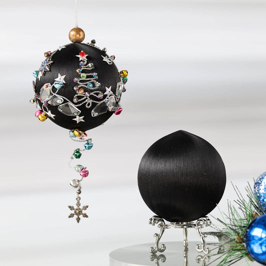 Jingle Bells - DIY Push Pin Ornament Kit includes black satin foam core ball, large glass beads, sparkling silver trim, sequins, and alloy snowflakes, set against a white brick backdrop.