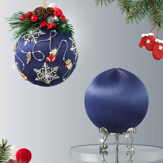 Blue Christmas ornament with decorative elements on a stand against a gray background