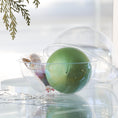 Load image into Gallery viewer, Materials for Push Pin Ornament "Leaves Are Falling" in olive are inside a round plastic clear container and have an olive colored satin foam core and a bag with beads and charms. (Olive)
