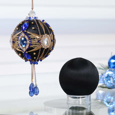 Christmas ornament kit showing two balls - one is a complete handmade black push pin ornament with blue gemstones , and the other is a satin foam ball to be decorated by Whim5seasons. (Black)