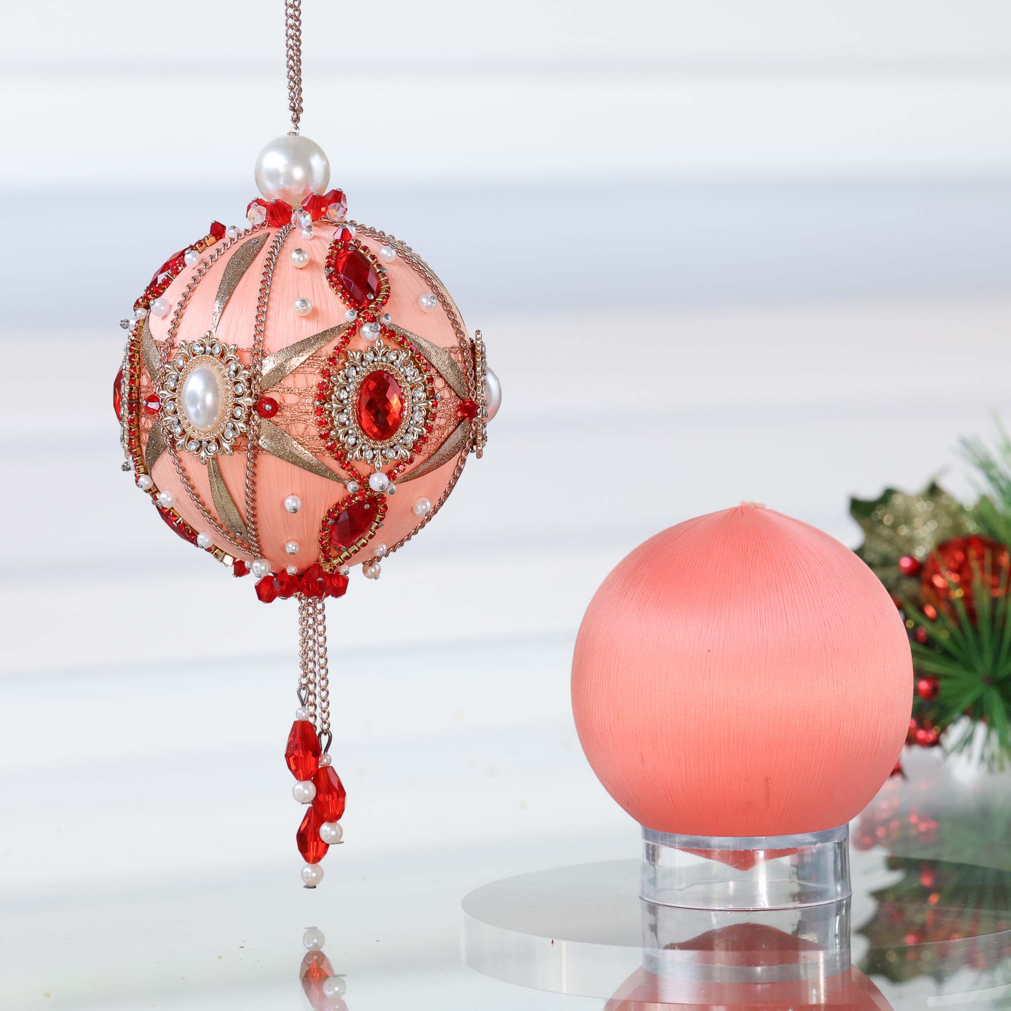 Two satin balls - one is a completed handmade push pin ornament, and the other is a coral-colored foam base to be used for a DIY Christmas craft project by Whim5seasons. (Coral)