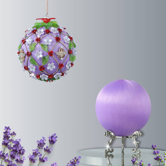 Decorative purple ball with floral embellishments on a stand against a white background with bee charm and a red flower on top by Whim5seasons.