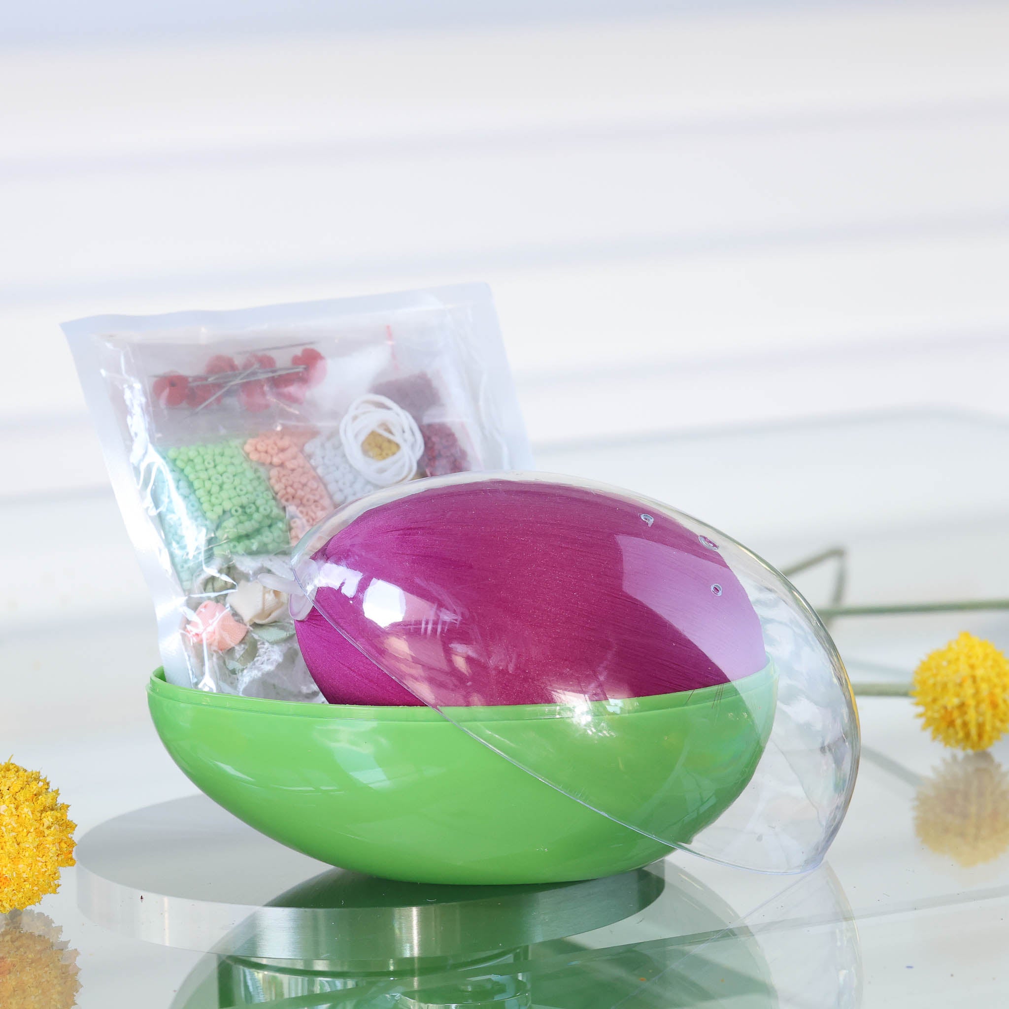Green  storage container with a clear lid includes a push pin ornament kit: a purple satin egg and a packages with various colored seed beads by Whim5seasons. (Purple)
