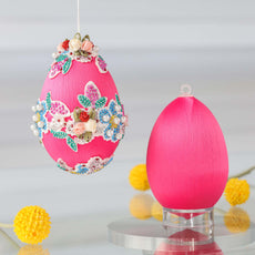Large pink satin Easter egg push pin ornament kit with floral embellishments on a white background and a reflective surface by Whim5seasons. (Deep Pink)