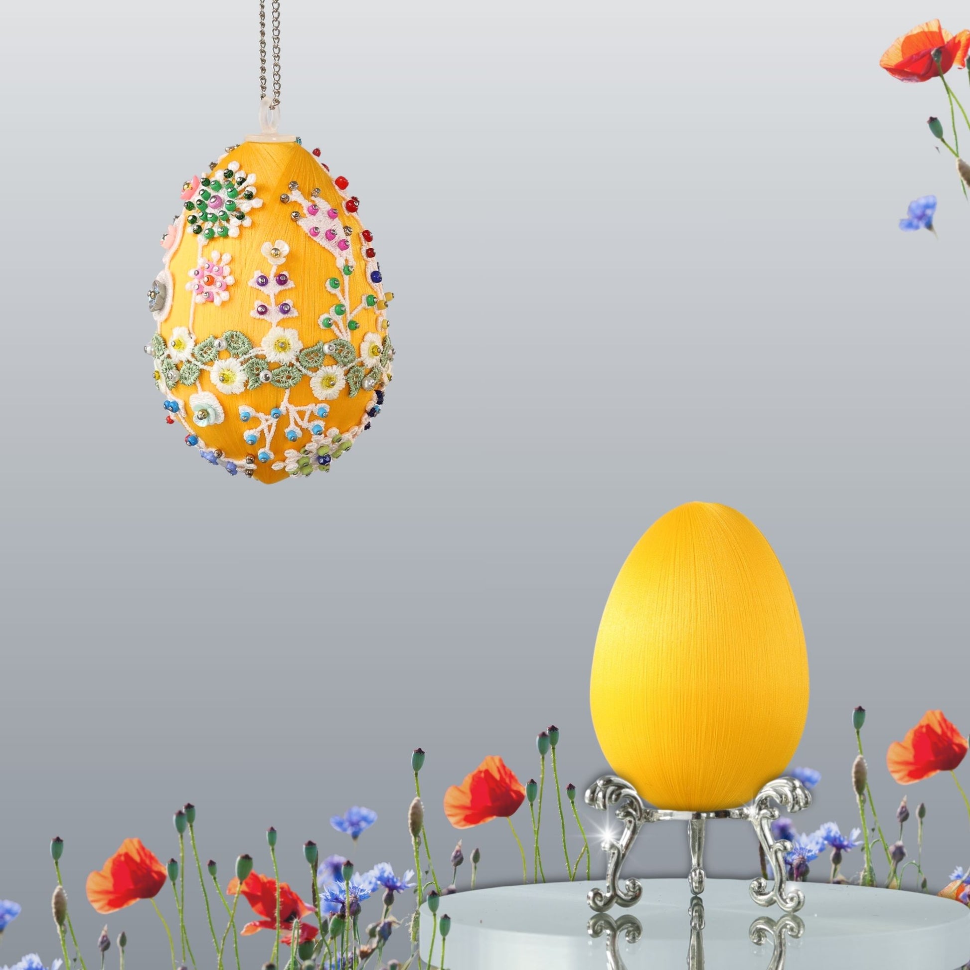 Yellow Easter egg push pin ornament  with floral patterns and colorful beads hanging on a chain against a neutral background by Whim5seasons.