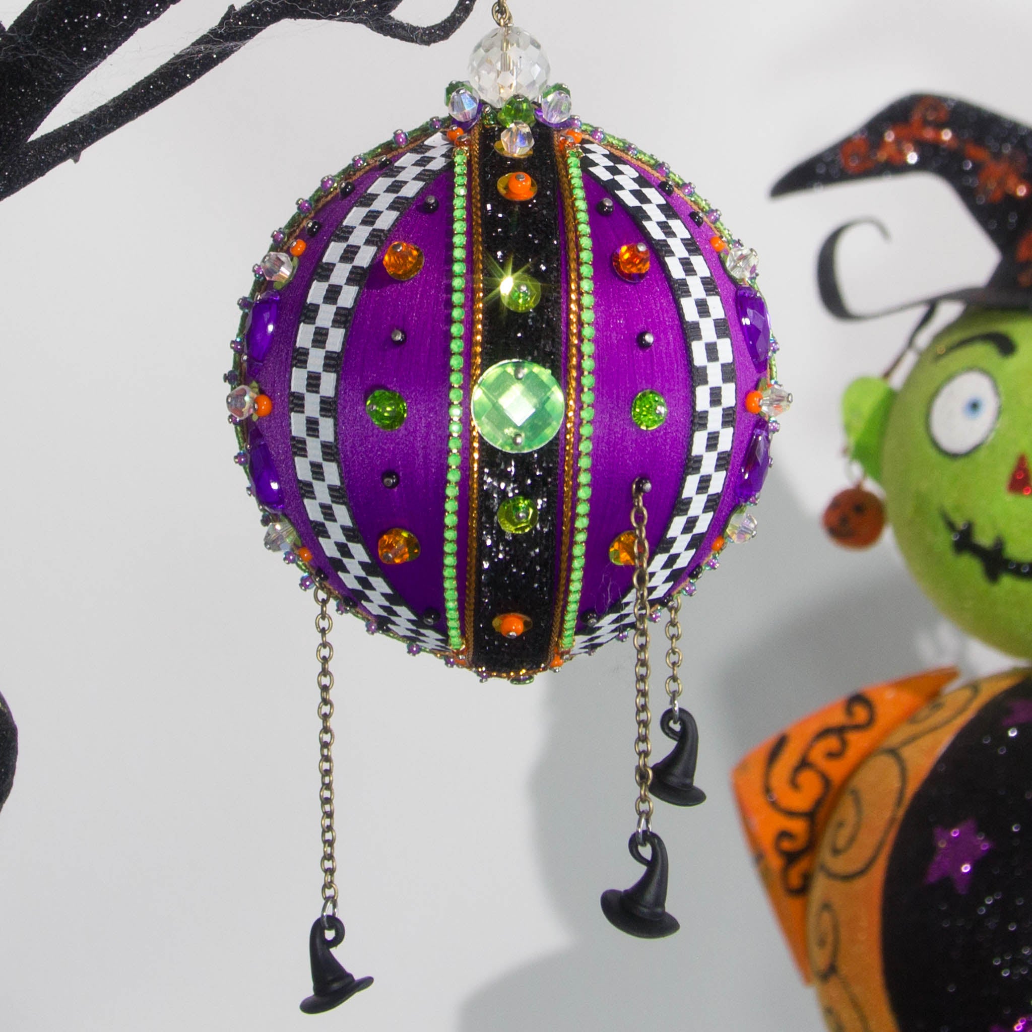 Front view of Halloween handmade ornament adorned with mini witch hat charms. (Indigo)