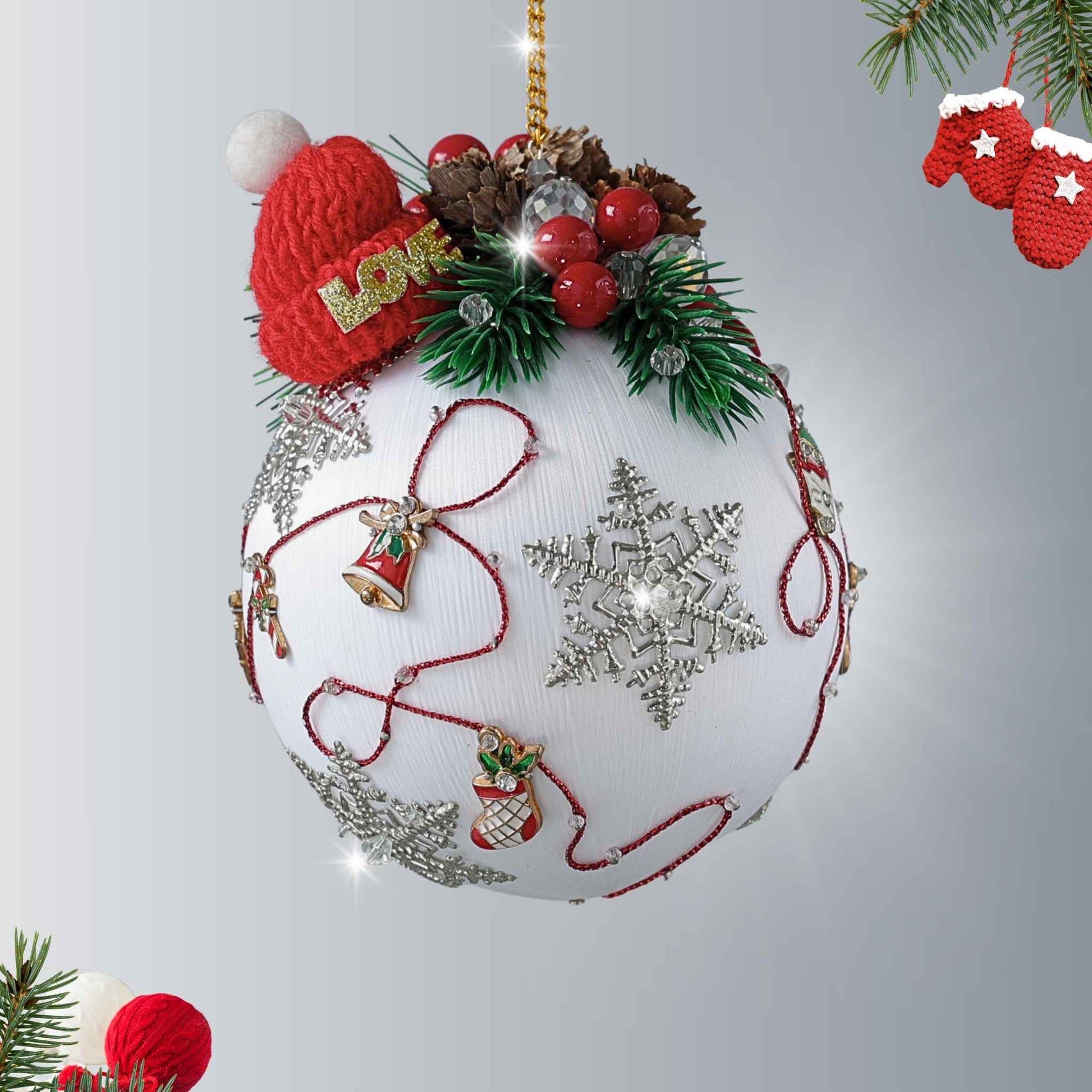 Decorative handcrafted white Christmas ornament with miniature knit red hat, berries, evergreen accents, and snowflake design on a white background by Whim5seasons.