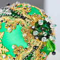 Load image into Gallery viewer, A close-up of a handmade push pin ornament's bottom with glass beads, and metallic trim on a satin ball with a gray background.   (Green)
