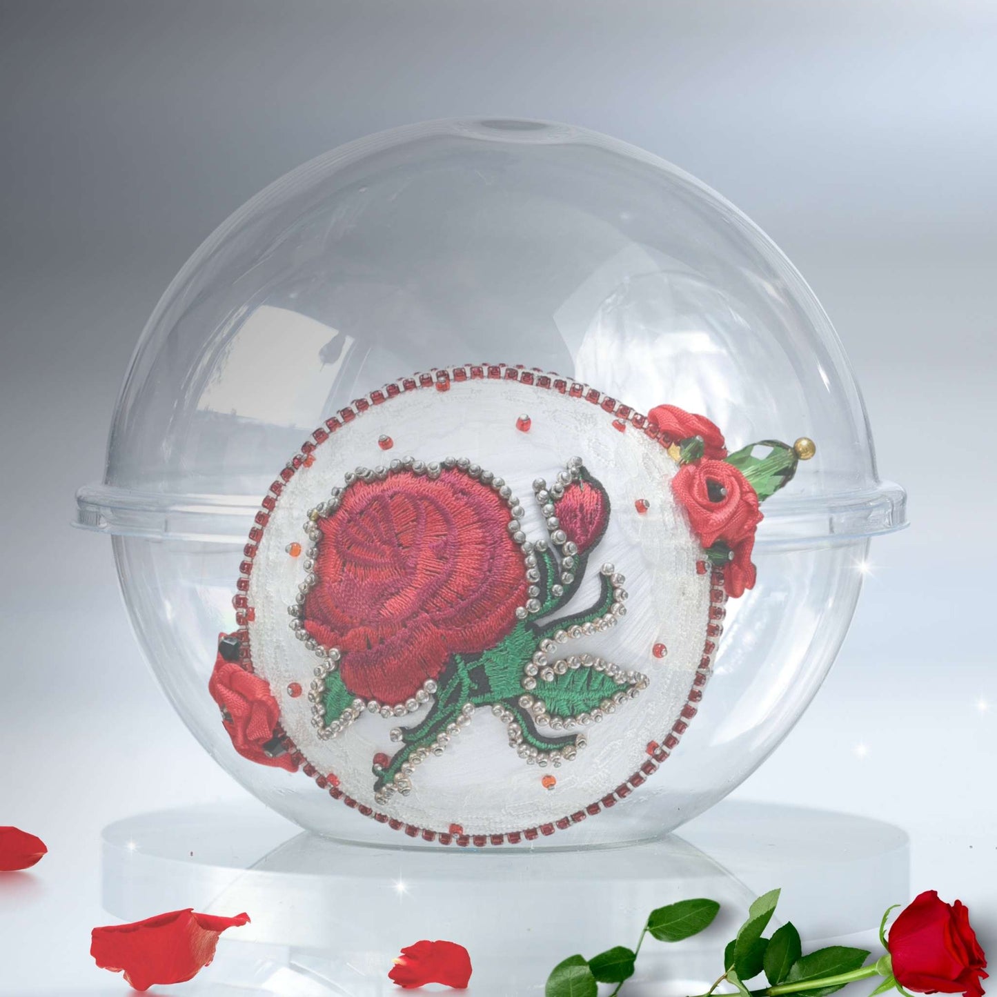 White handmade satin push pin ornament in a clear round plastic container with rose petals on a gray background by Whim5seaons.
