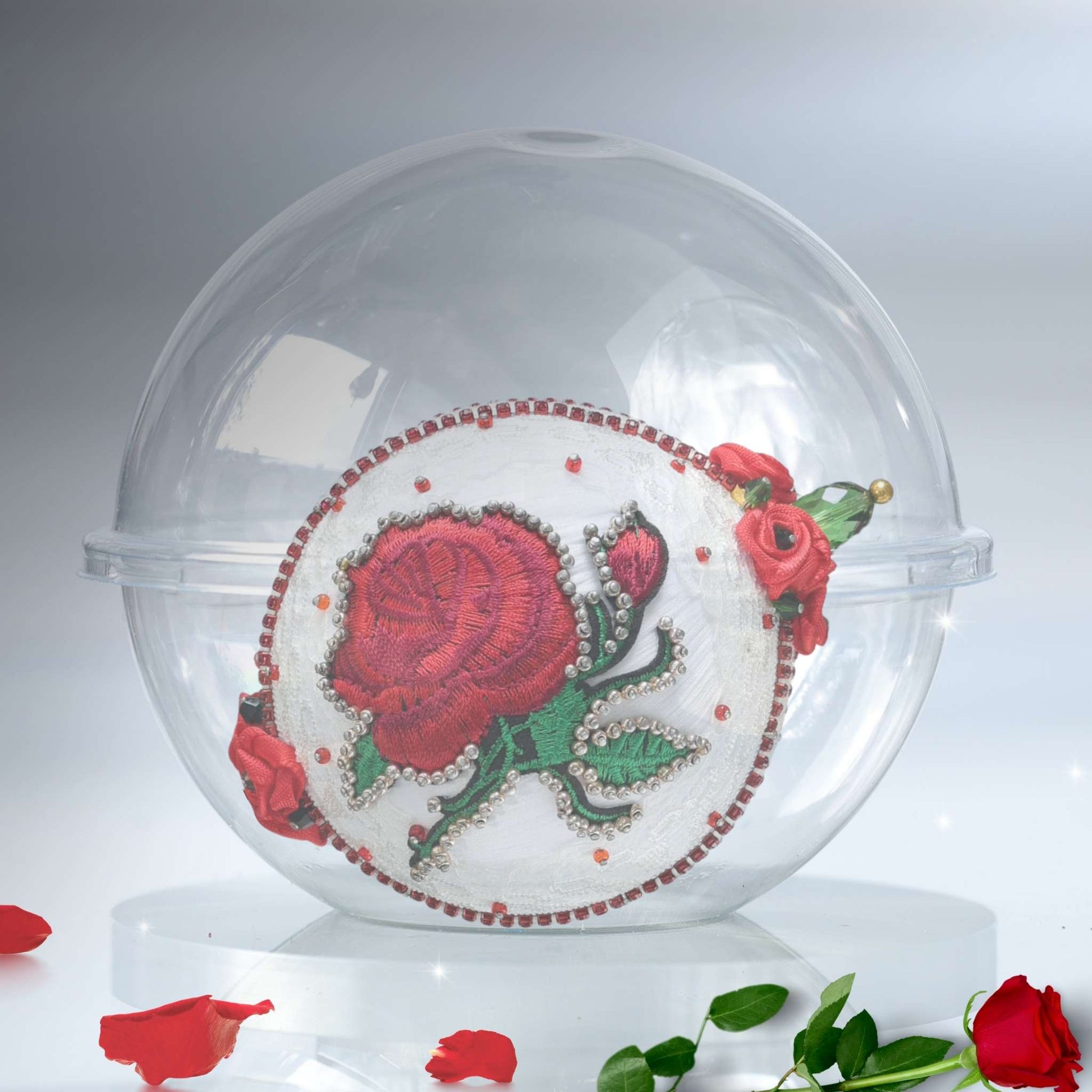 White handmade satin push pin ornament in a clear round plastic container with rose petals on a gray background by Whim5seaons.