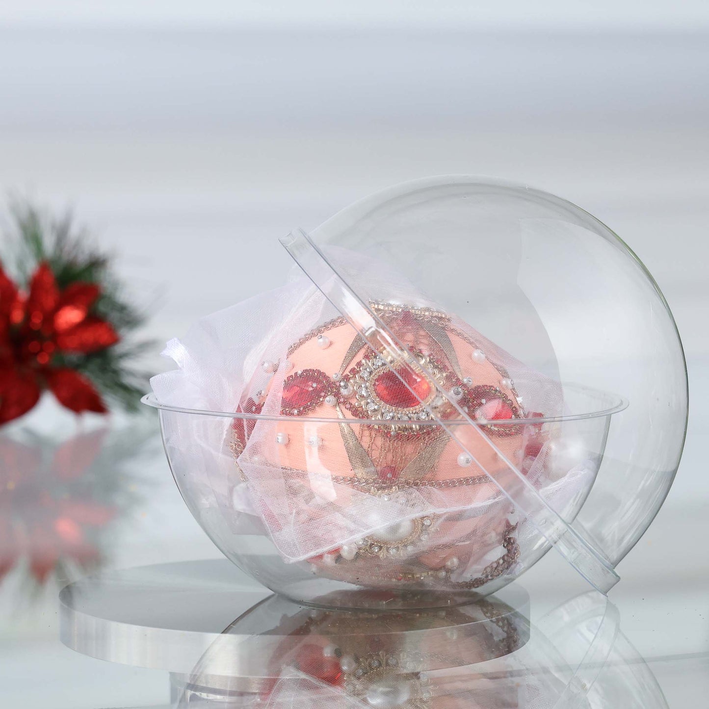 Handmade satin push pin ornament featuring large red cameos, gold beads, and gold chains, in a clear round storage container with a Christmas branch in the background by Whim5seasons. (Coral)