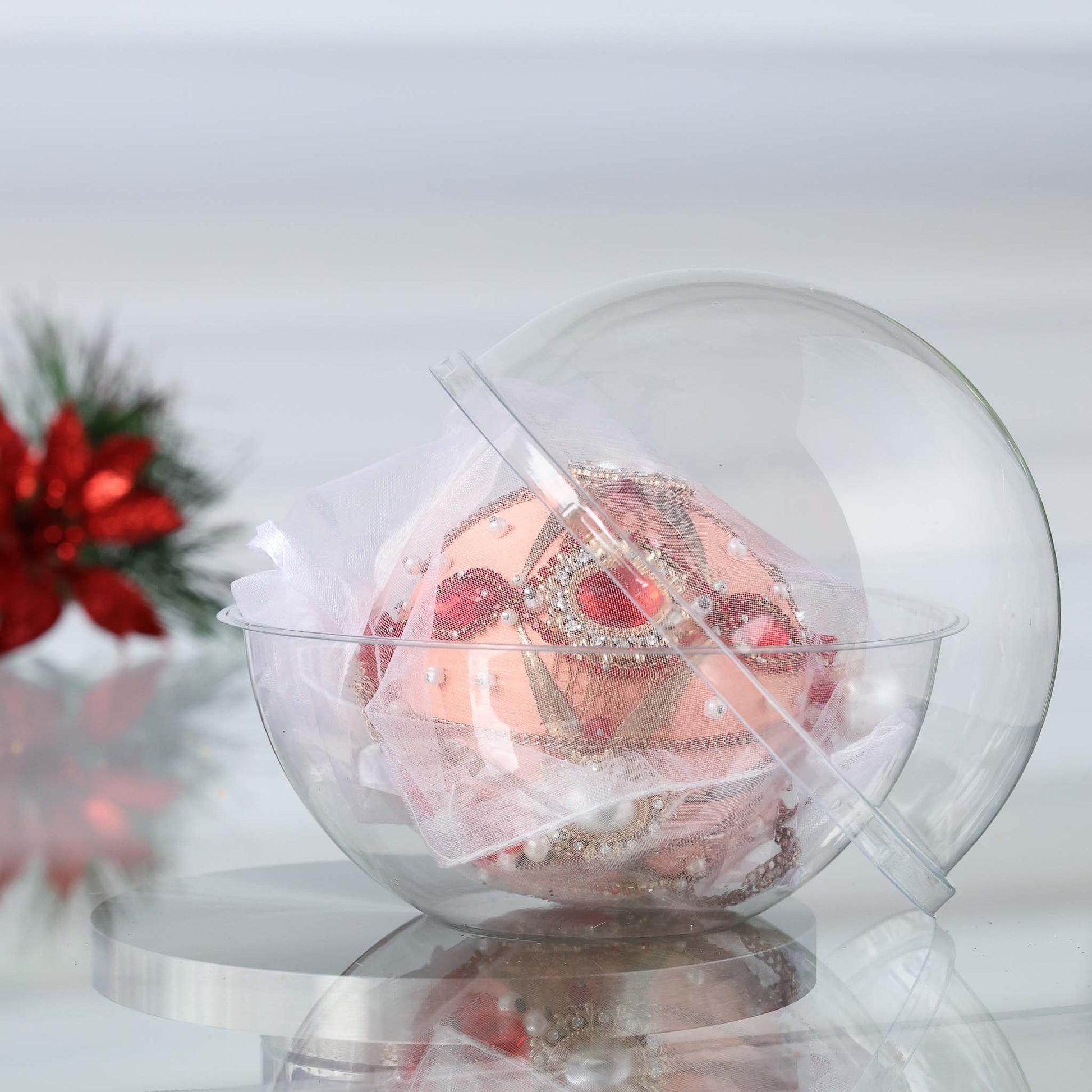 Handmade satin push pin ornament featuring large red cameos, gold beads, and gold chains, in a clear round storage container with a Christmas branch in the background by Whim5seasons. (Coral)