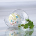 Load image into Gallery viewer, Satin push pin ornament Frosted Laurel in a clear storage container on a reflective surface with a holiday branch. (Khaki)
