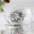 Load image into Gallery viewer, Handmade completed Christmas push pin satin ornament with silver stgar sequins inside a round clear storage container, with a pinecone on a light background.
