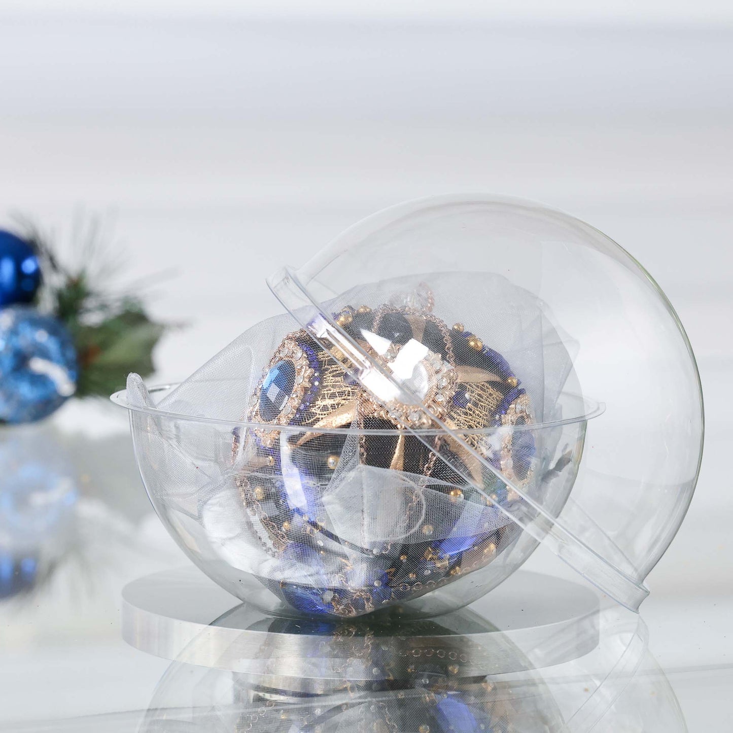 Clear plastic storage box with a handmade satin push pin black ornament inside, placed on a reflective surface with a gray background by Whim5seasons. (Black)