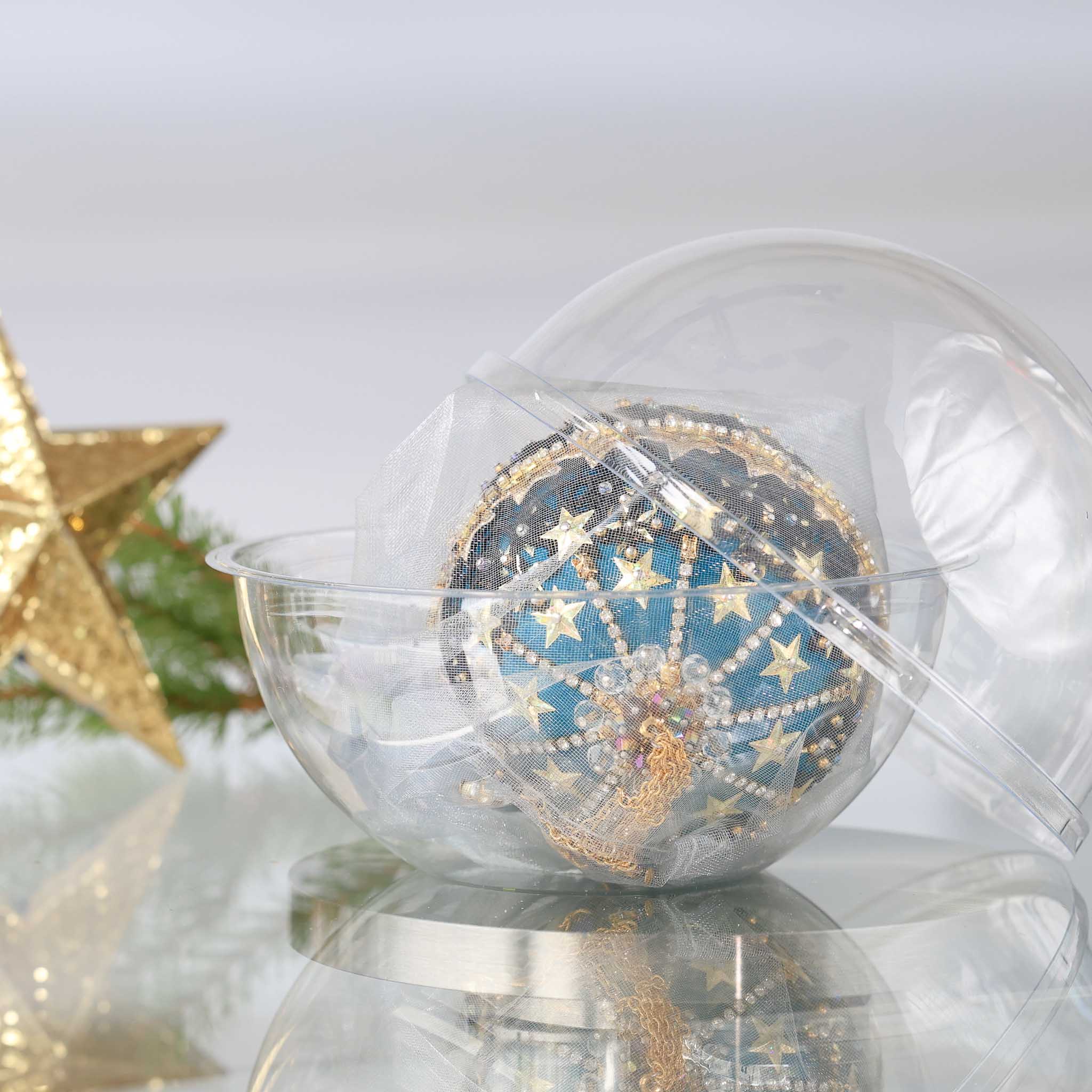 Completed Handmade Christmas Push Pin Ornament in a dark teal color with gold star design in a storage container set against a light background with a gold star and holiday greenery. (Dark Slate Blue)