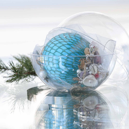 Handmade sequin & beaded teal-colored satin ornament inside a round plastic storage container with holiday greenery by Whim5seasons.