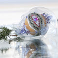 Load image into Gallery viewer, Handmade satin push pin ornament in a clear storage container, richly embellished with red round rhinestones, gold trim, rows of silver sequins, and large blue beads.
