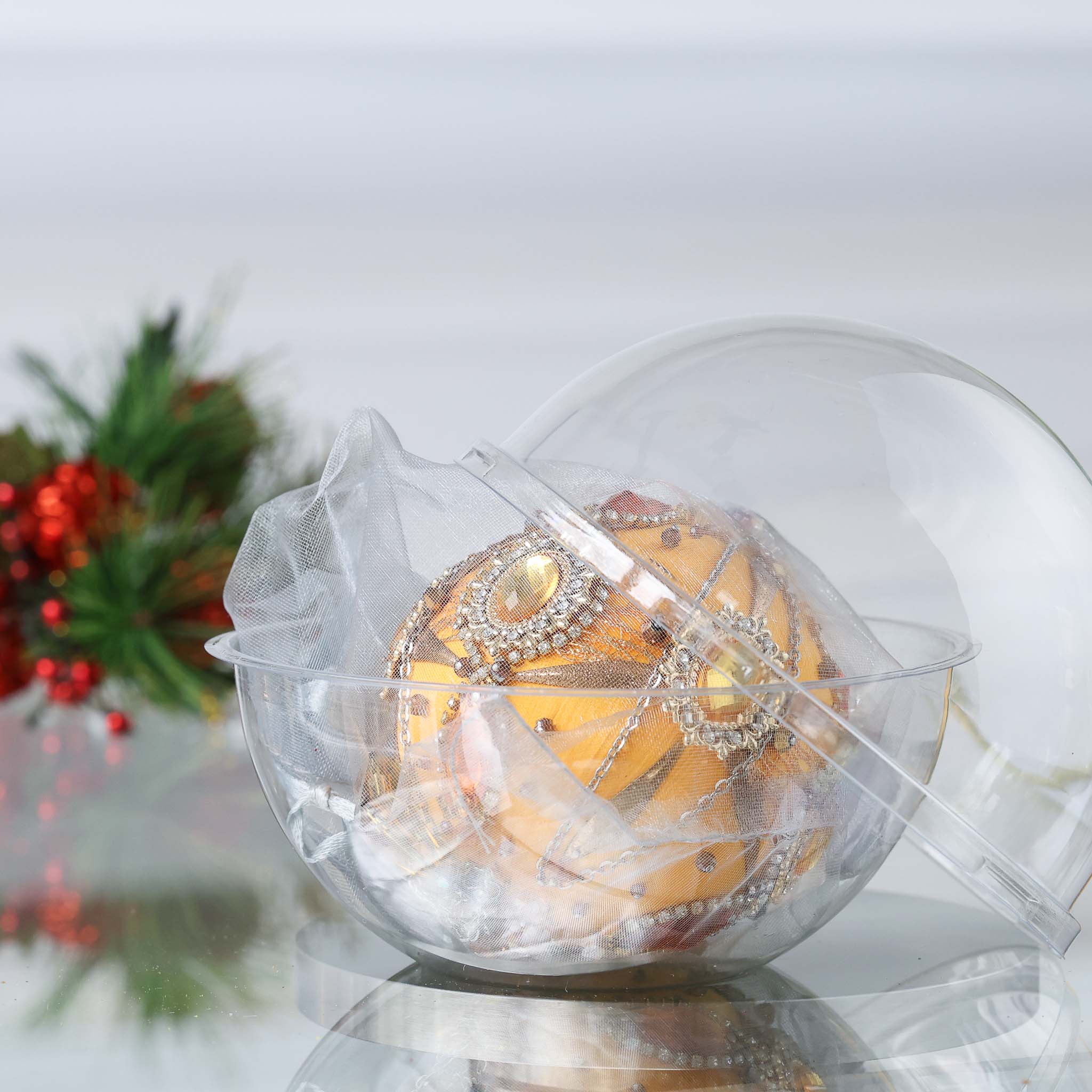 Decorative satin sequin & beaded Christmas ornament wrapped in organza in a clear container with festive background by Whim5seasons. (Light Yellow)