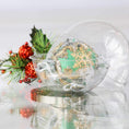 Load image into Gallery viewer, Plastic round clear container with a green handmade Christmas push pin ornament inside on a light gray background with holiday decor. (Green)
