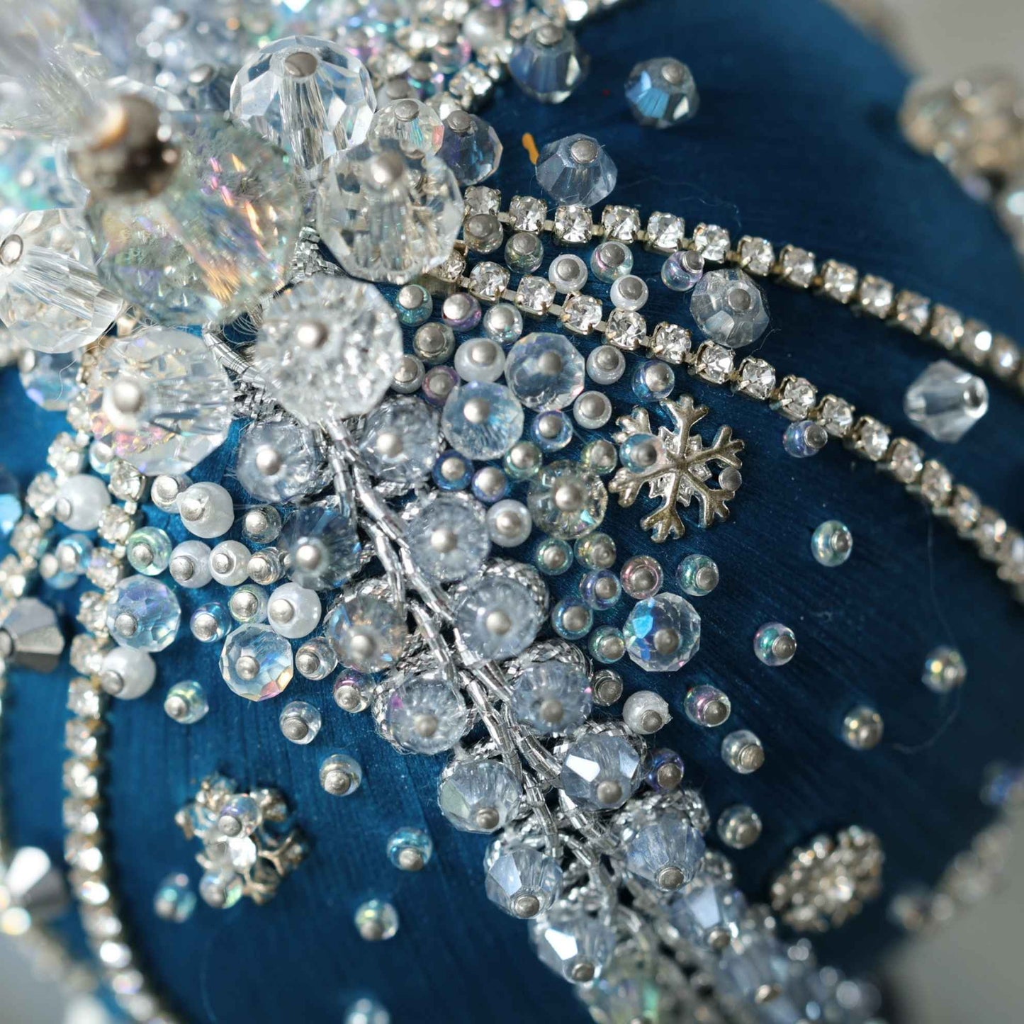 A close-up detail of a handmade Polar Night beaded ornament showing glass sparkling beads pinned to a Pam core with dressmaker pins by Whim5seasons.