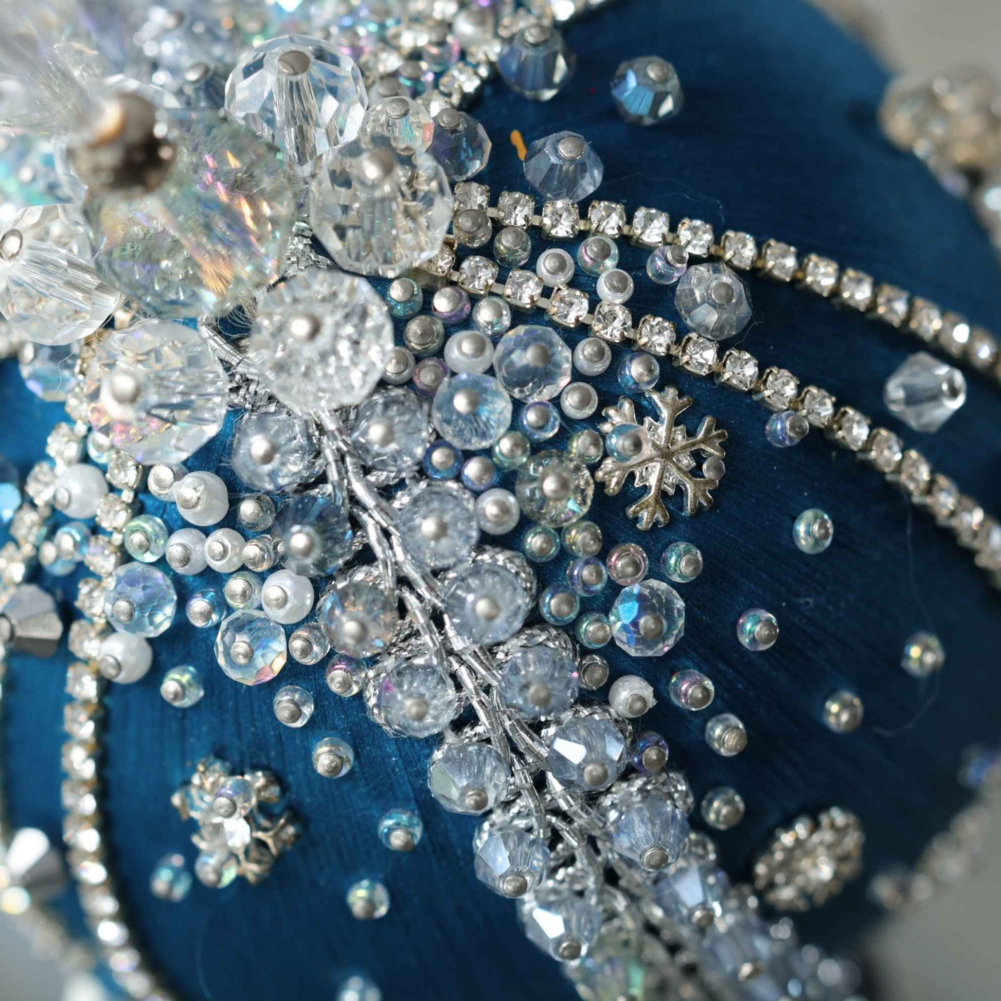A close-up detail of a handmade Polar Night beaded ornament showing glass sparkling beads pinned to a Pam core with dressmaker pins by Whim5seasons.