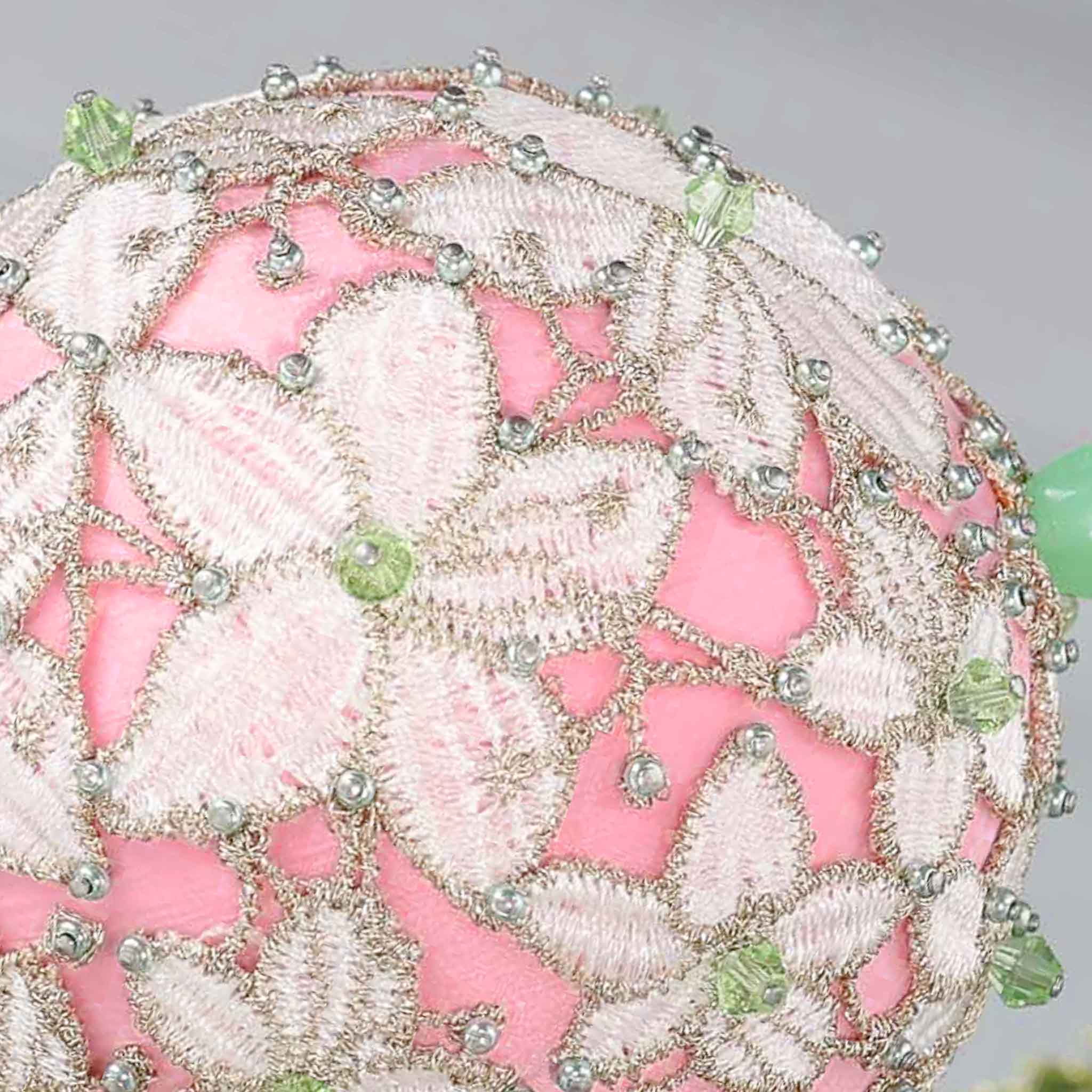 Close-up of a decorative pink push pin satin ball showing small beads pinned with dressmaker pins by Whim5seasons.