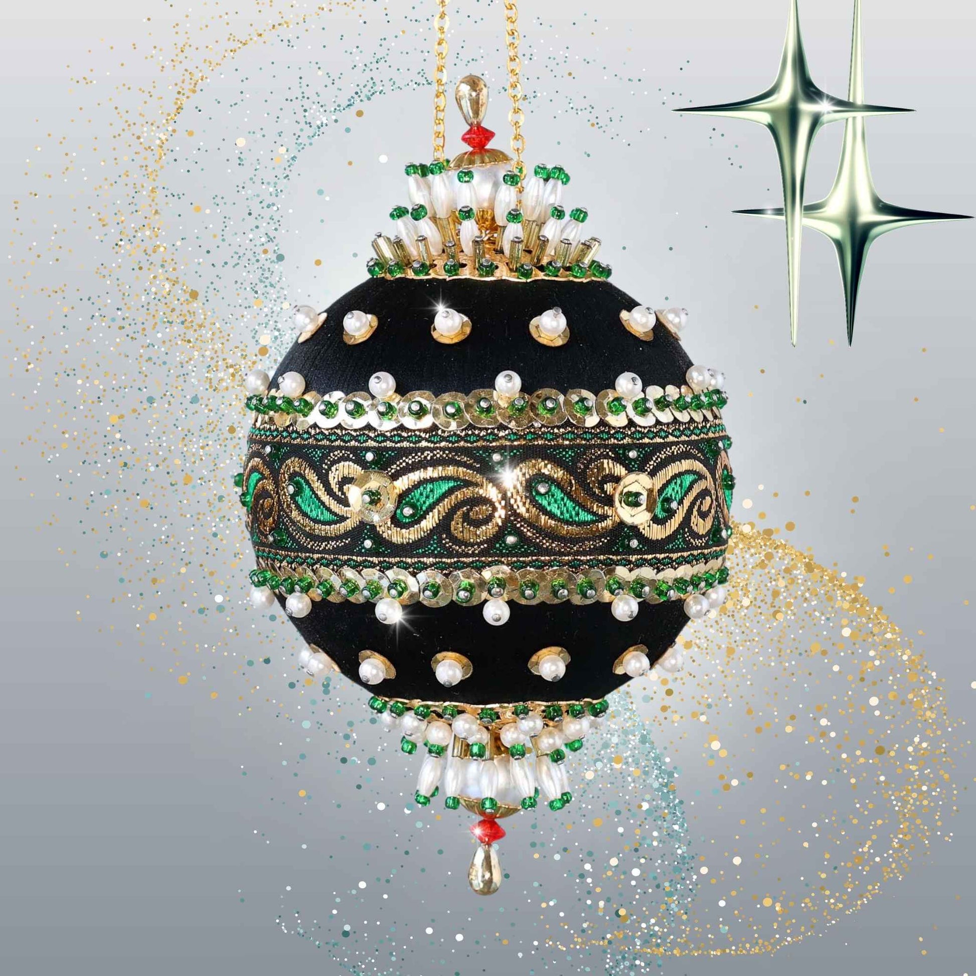 Handmade black satin push pin ornament with a rich gold and green trim, pearl beads, and larfge gold metallic charms, hanging on a gold chain in front of light gray background by Whim5seasons.