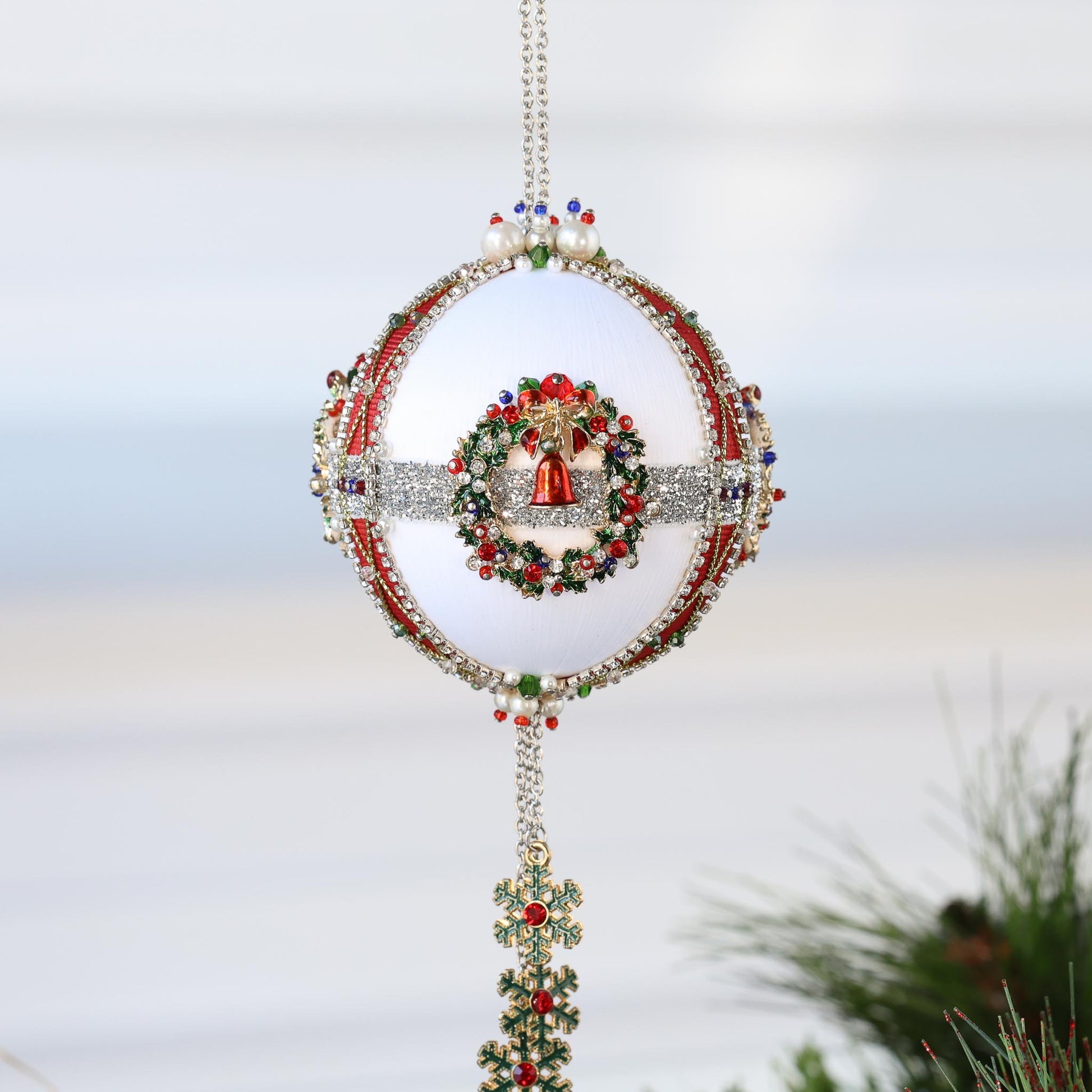 Decorative Christmas ornament with a bell and wreath design on a white background by Whim5seasons.