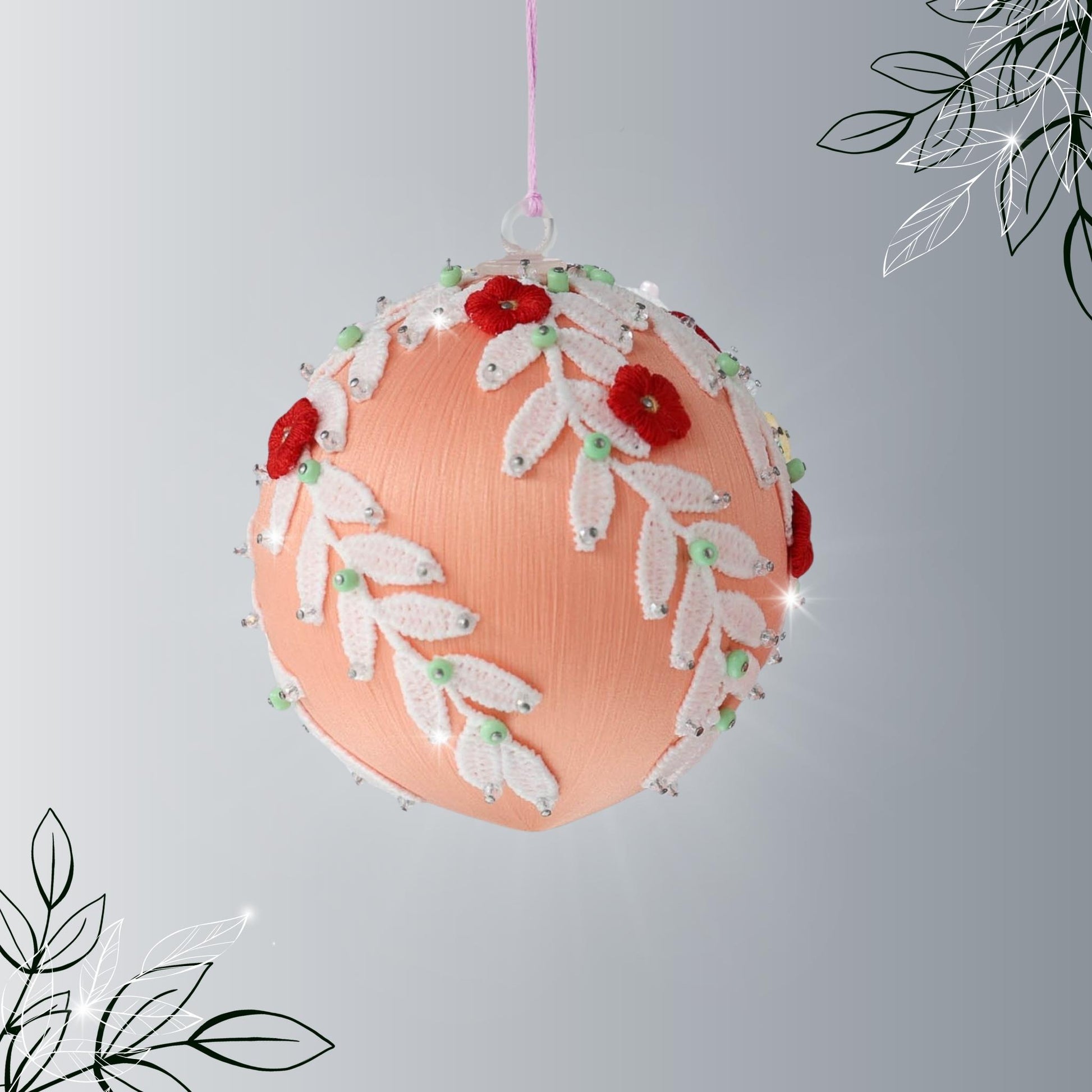 Handmade Christmas or Easter Beaded push pin Ornament Ball embellished with small red embroidered flowers, white trim, and beads hanging from a holiday branch by Whim5seasons.
