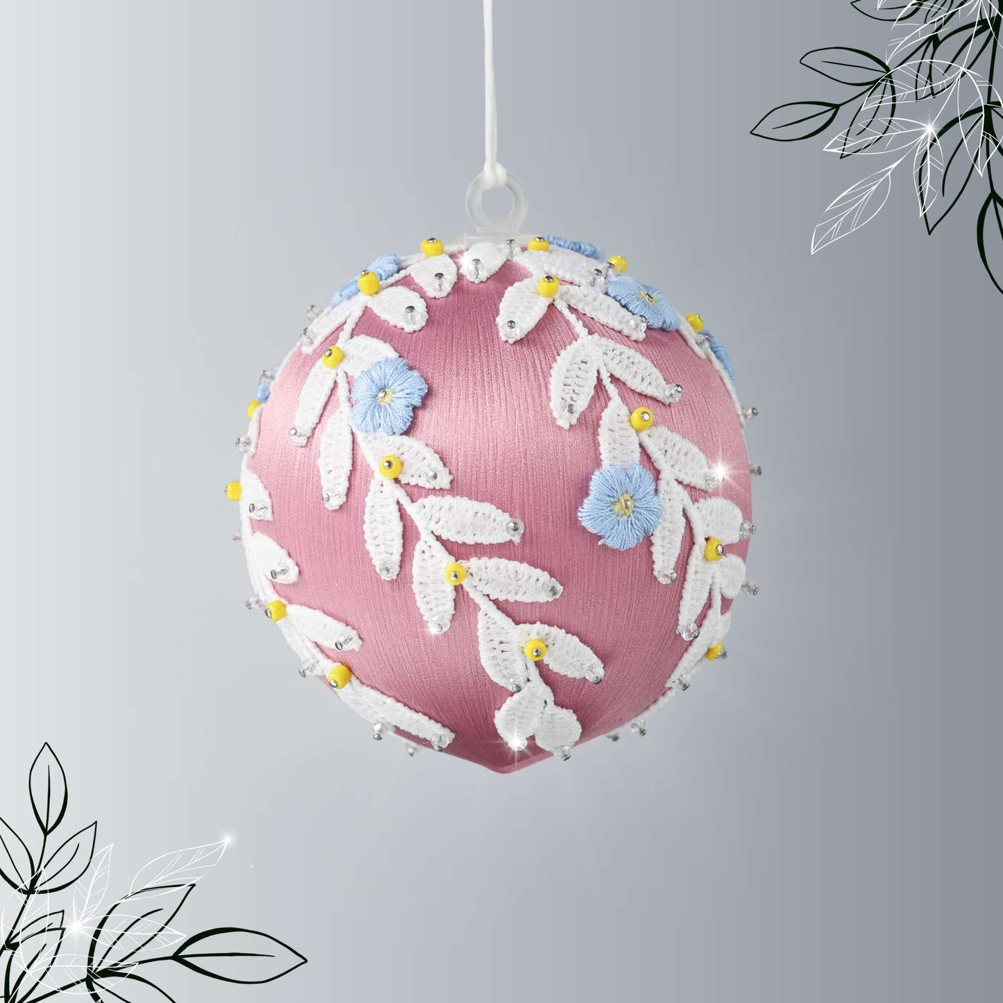 Handmade Christmas or Easter Beaded push pin Ornament Ball with blue embroidered flower patches, white trim, and beads pinned to a satin foam core and hanging on a light gray background by Whim5seasons.