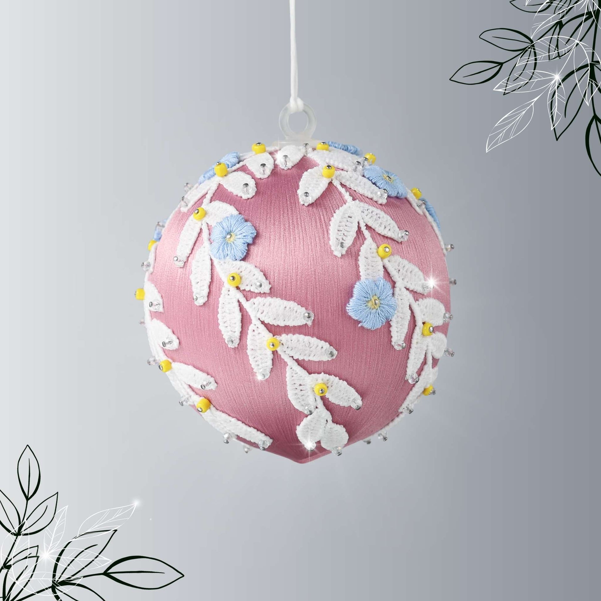 Handmade Christmas or Easter Beaded push pin Ornament Ball with blue embroidered flower patches, white trim, and beads pinned to a satin foam core and hanging on a light gray background by Whim5seasons.