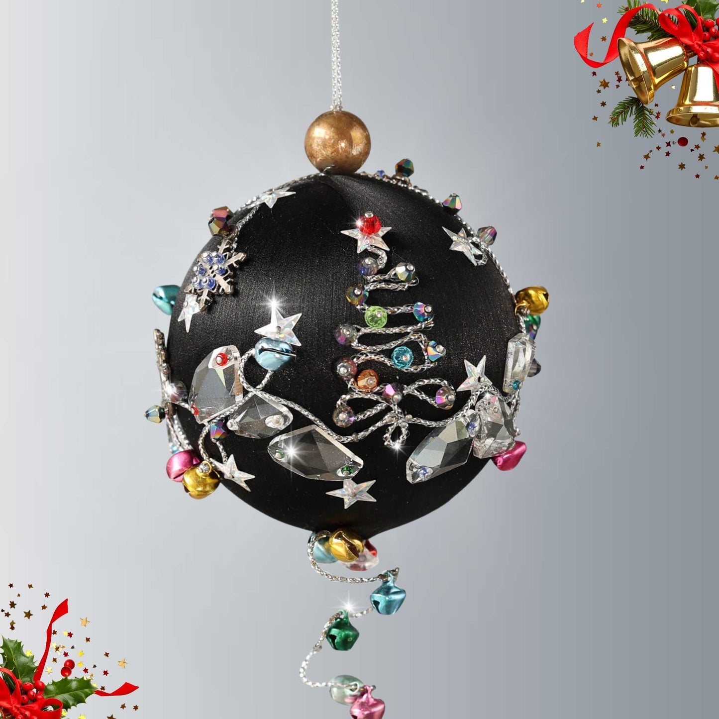 Handmade Christmas satin push pin ornament in black with large clear glass beads, silver snowflake, and tiny jingle bells  on a white background with a green evergreen branch by Whim5seasons.