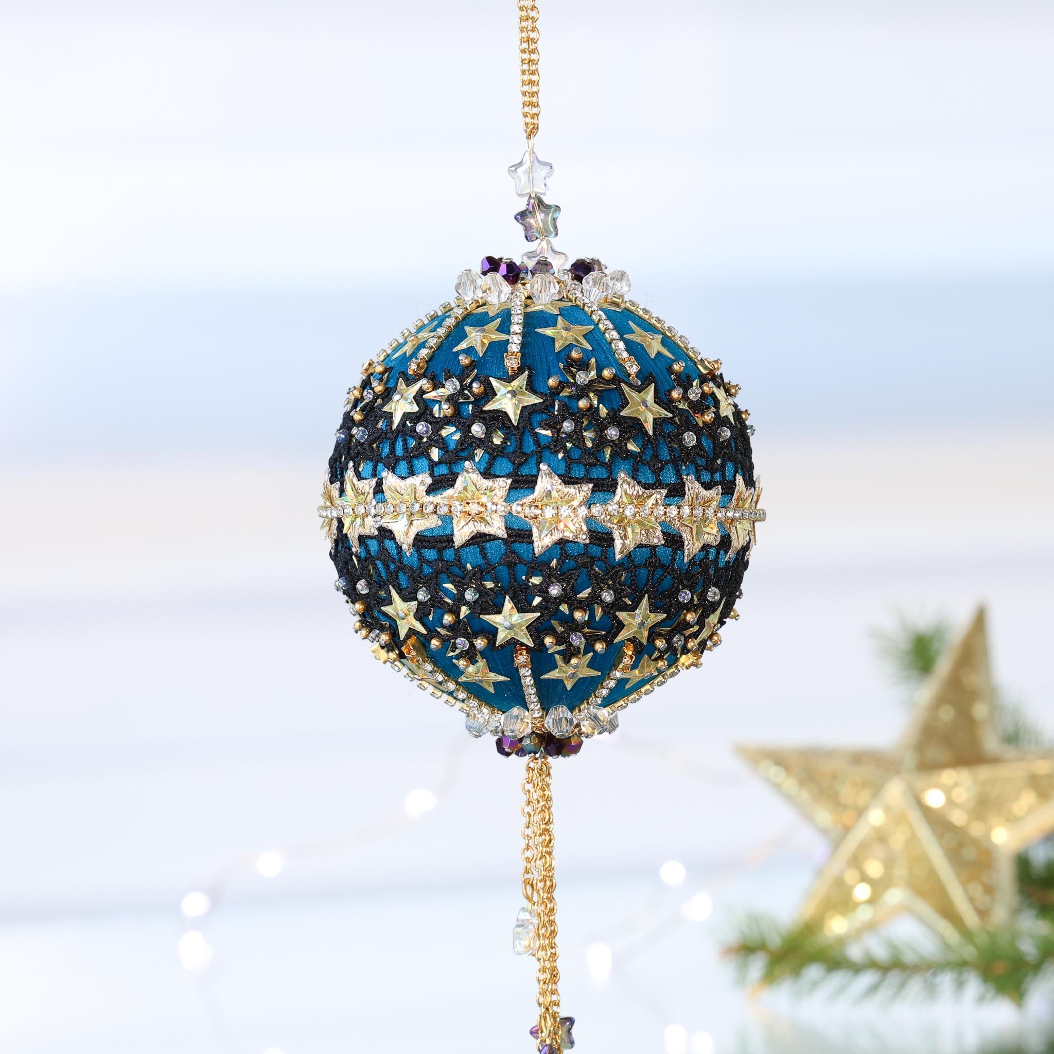 Handmade Christmas Push Pin Ornament from Whim5seasons features sparkly rhinestone chains, gold star trim ,and star sequins pictured against a light gray background with a gold star. (Dark Slate Blue)