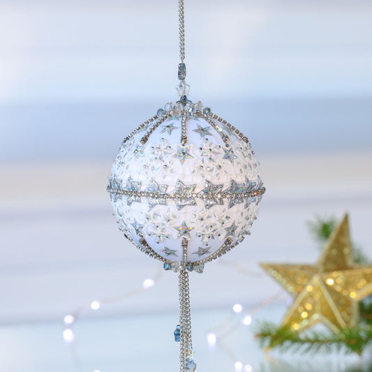 Handmade Christmas push Pin Ornament New Year Star is a white satin ball embellished with silver sequins and rhinestone chains set against a light background with a gold star. (White)