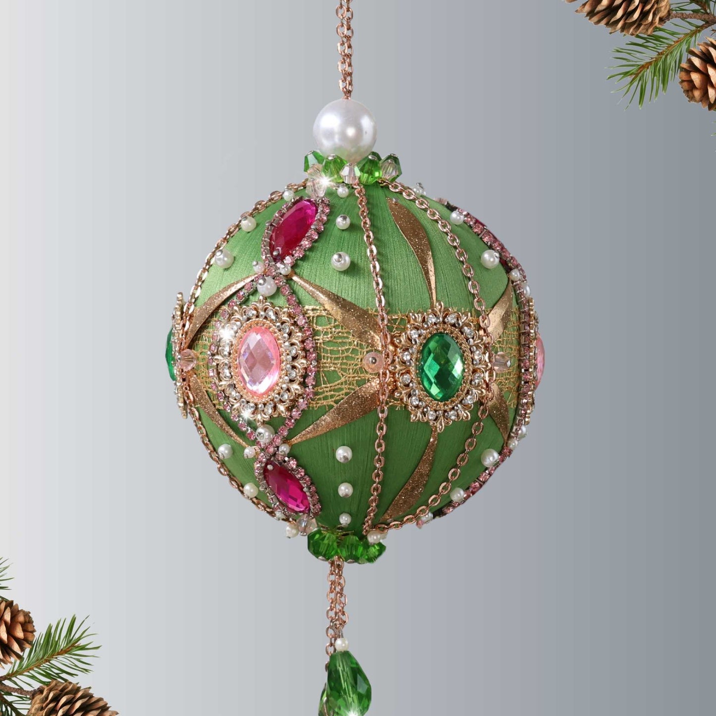 A side of a handcrafted green beaded push pin Christmas ornament with gold beads applied to the satin foam core with dressmaker pins by Whim5seasons.