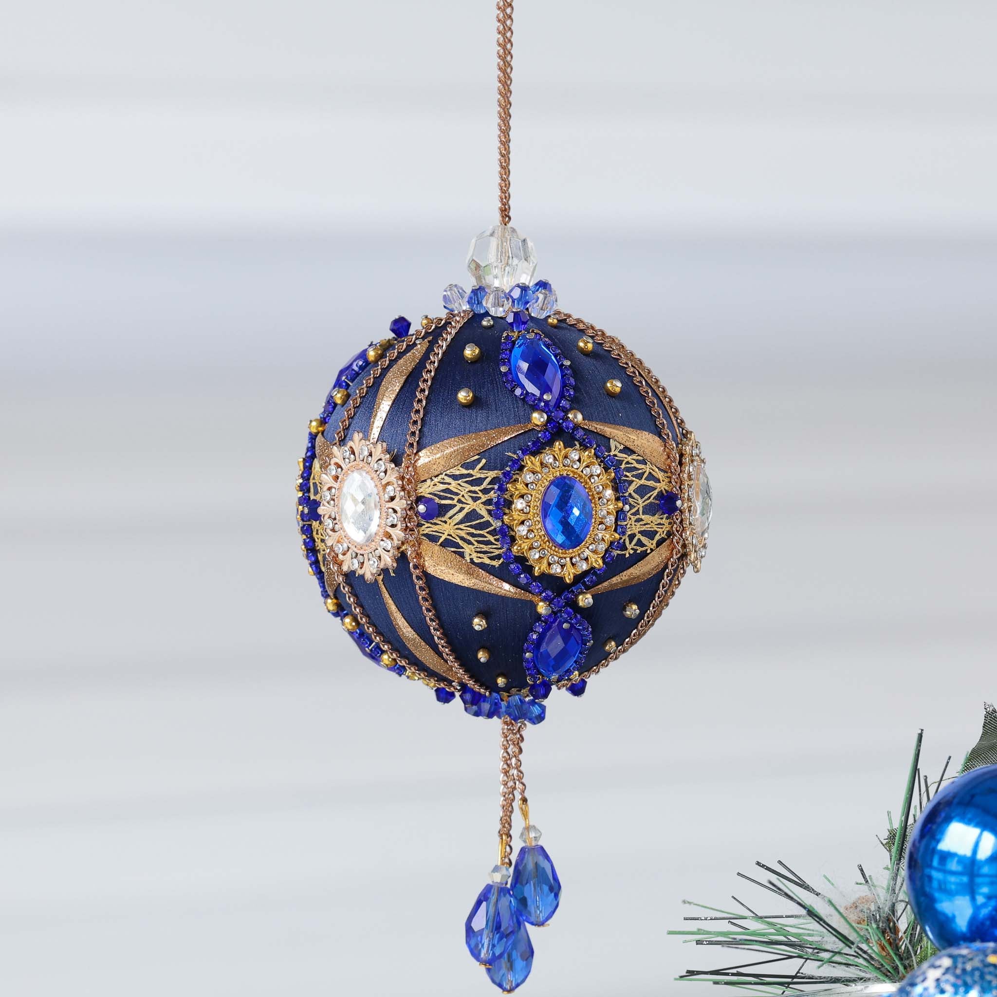 Handcrafted vintage style satin push pin ornament with dark blue and crystal framed pearl cameos, rhinestone chains, and gold beads, hanging on a gold chain by Whim5seasons. (Navy)