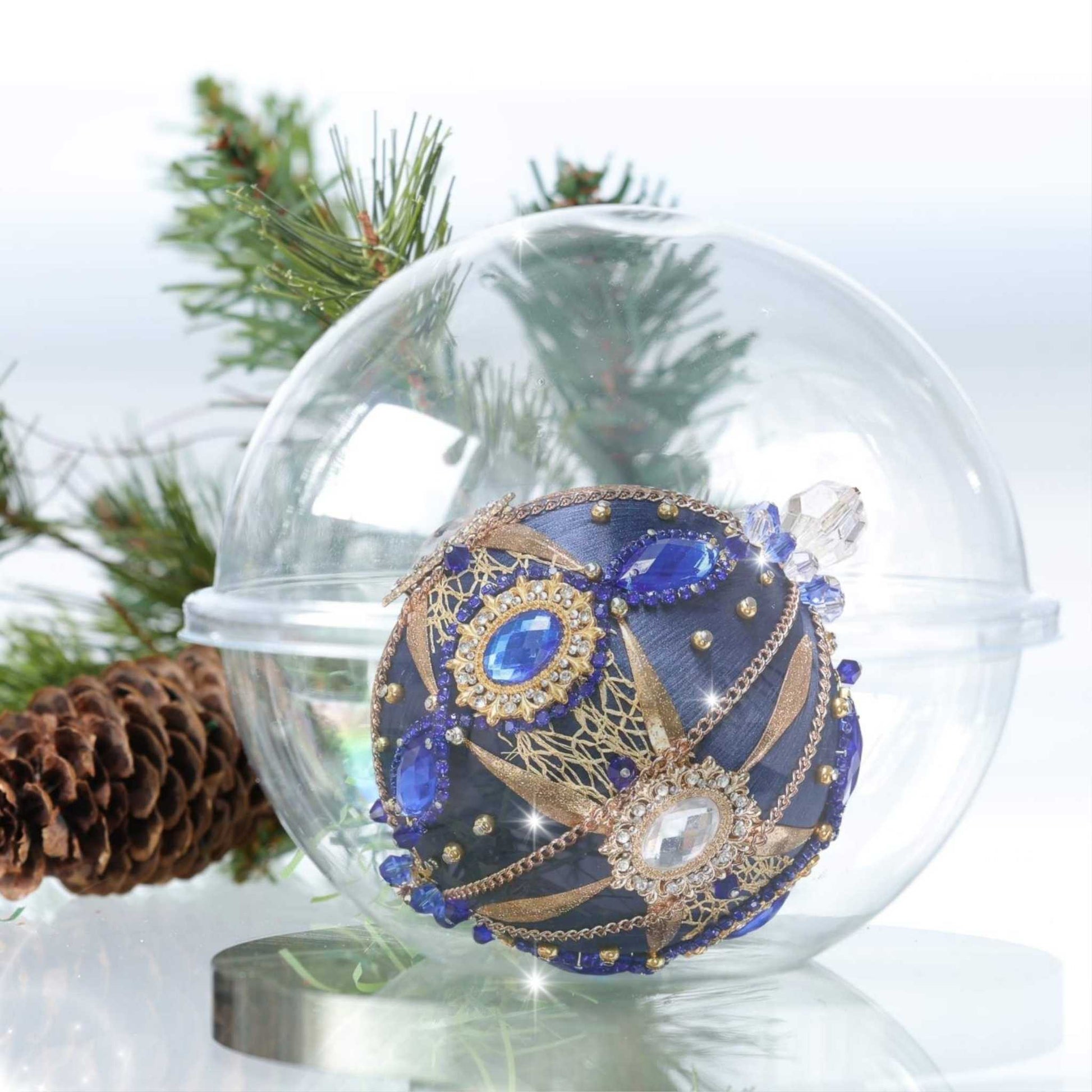 A side of a satin handcrafted dark blue  push pin Christmas ornament with gold beads and cameos applied to the satin foam core with dressmaker pins by Whim5seasons.