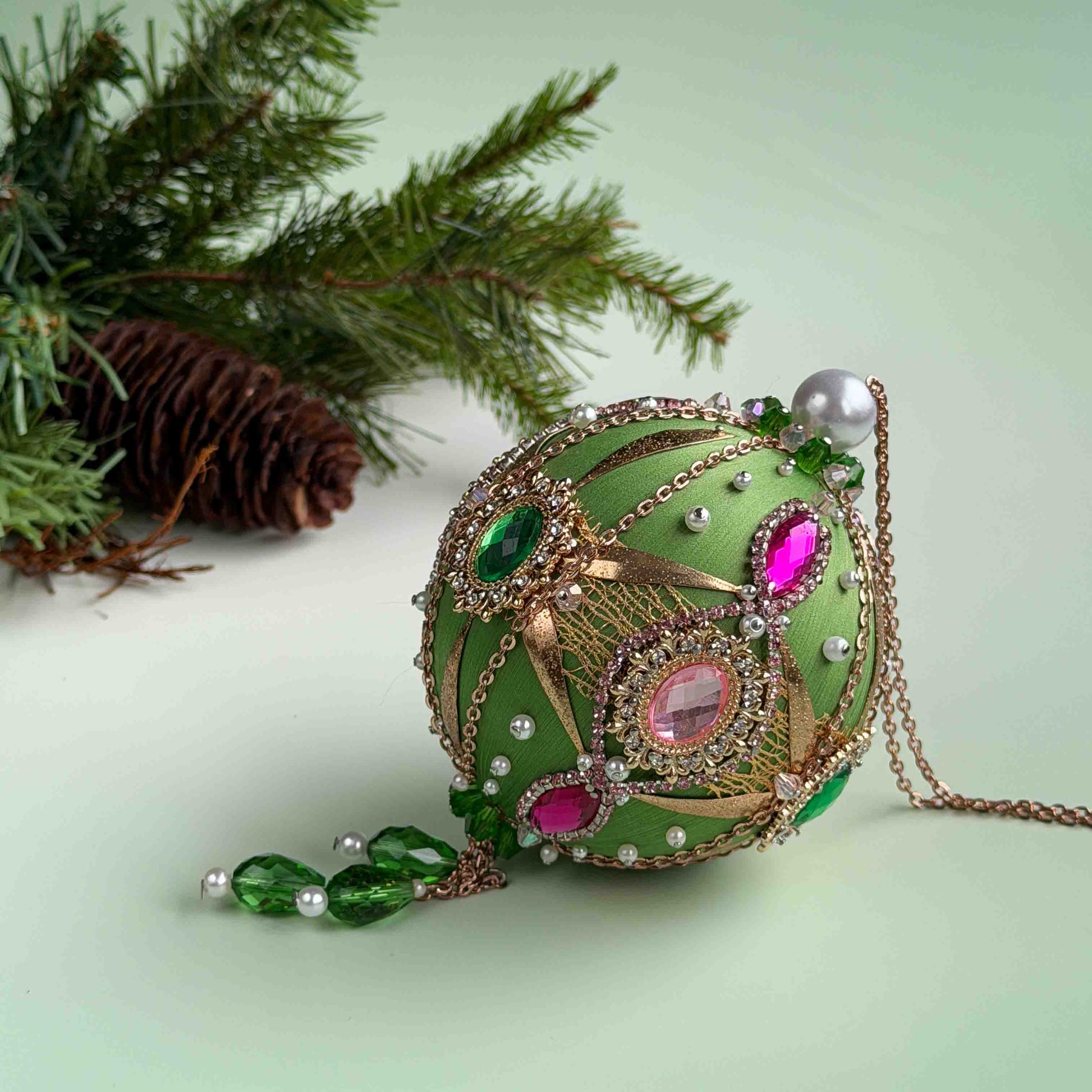 Beautiful handmade satin Christmas ornament with green and pink cameos on a soft pale gradient background with holiday greenery by Whim5seasons.  (Olive)