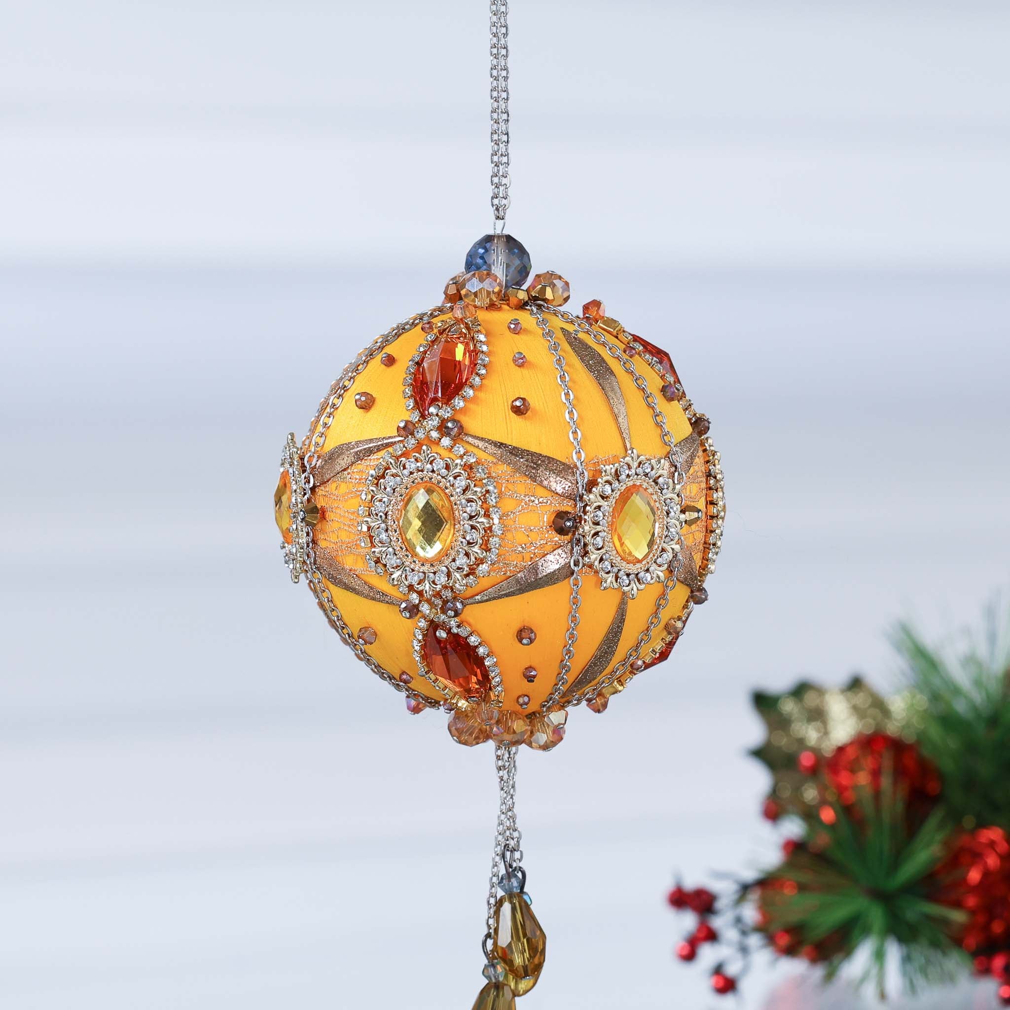 Decorative handmade yellow satin ornament with gemstones on a white background featuring bead tassel and gold chains by Whim5seasons. (Light Yellow)