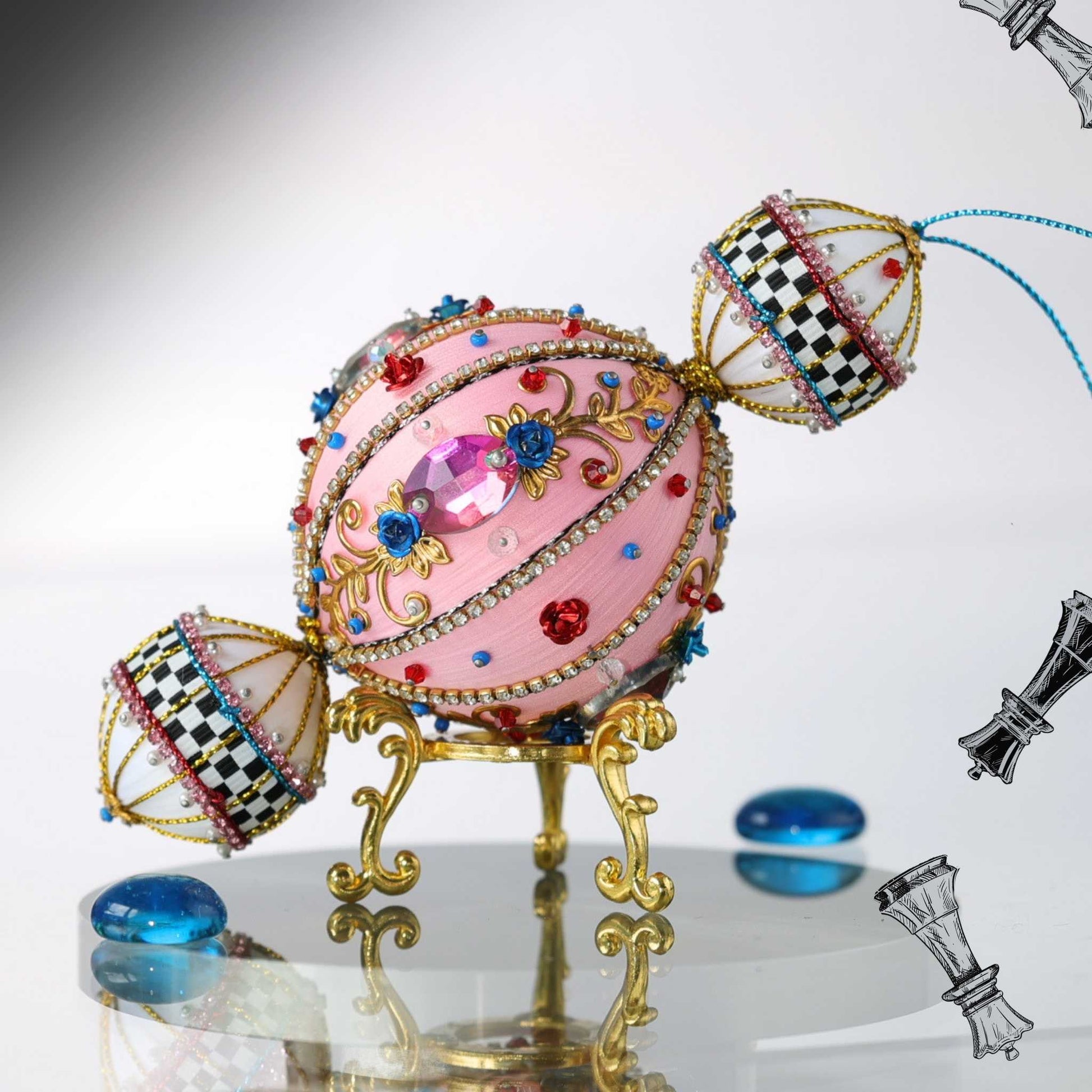 Decorative handmade push pin ornament featuring pink satin ball with intricate design and colorful gemstones on a reflective surface by Whim5seasons.