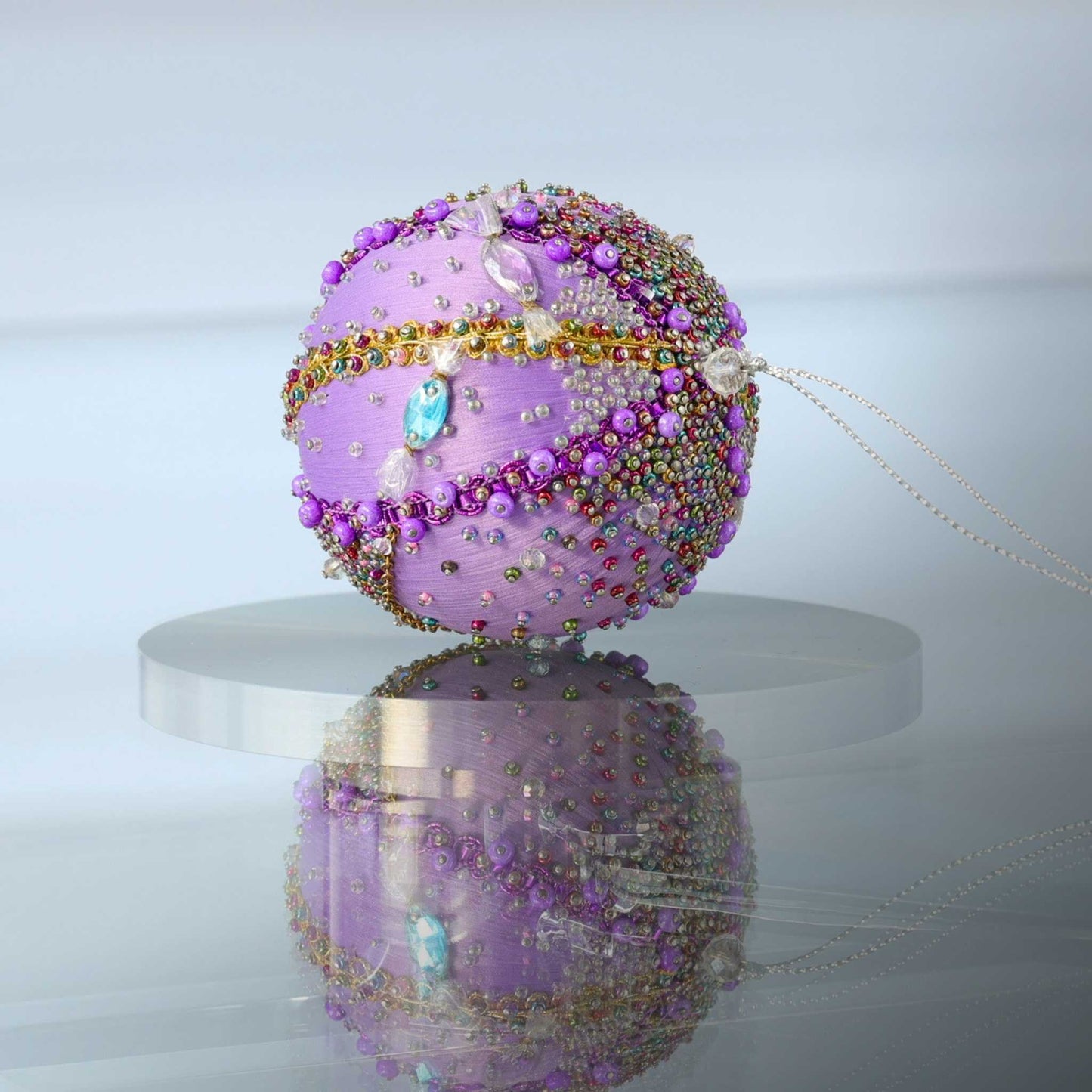 Handmade Beaded Christmas Ornament Candy by Whim5seasons in lavender color on a reflective surface.