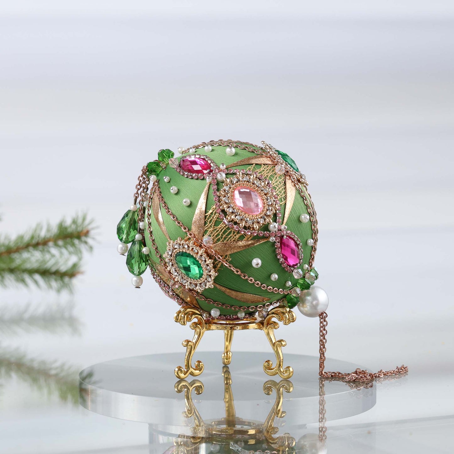 A side of a handcrafted green beaded push pin Christmas ornament with gold beads applied to the satin foam core with dressmaker pins by Whim5seasons. (Olive)