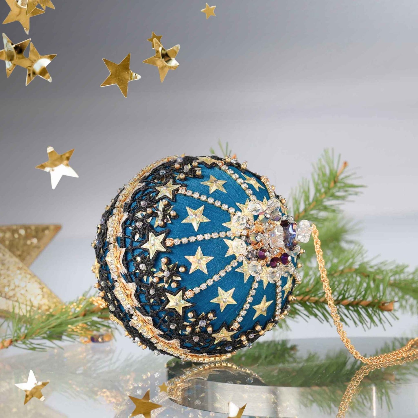 A close up detail of a Handmade Christmas Push Pin Ornament New Year Star showcasing sparkling rhinestones and crystal beads, on a reflective surface by Whim5seasons.