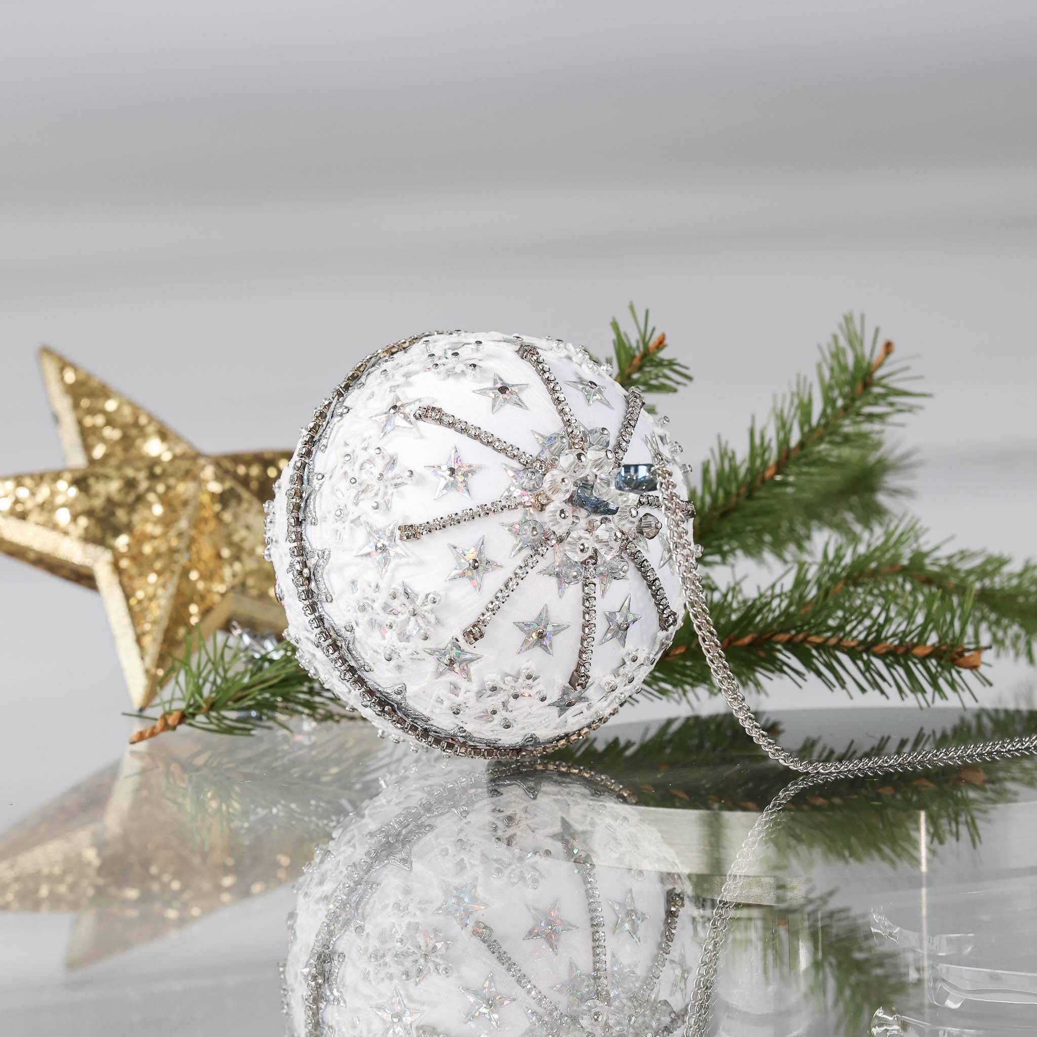 Completed Handmade Christmas Push  Pin Ornament with star design on a reflective surface with greenery and gold star in the background. (White)